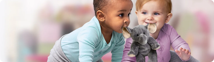 Two infants holding a toy elephant by its ears in their mouths.