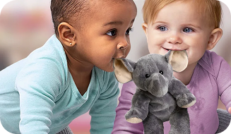 Two infants holding a toy elephant by its ears in their mouths.